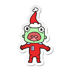 sticker cartoon of a weird alien communicating wearing santa hat