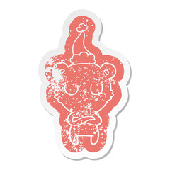 peaceful cartoon distressed sticker of a polar bear wearing santa hat