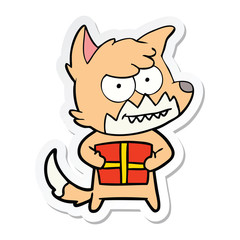 sticker of a cartoon grinning fox with present