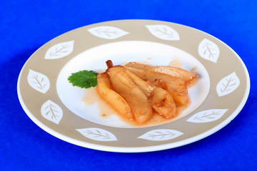 Pear candied in mixture of wine and honey with cinnamon sugar and nutmeg.