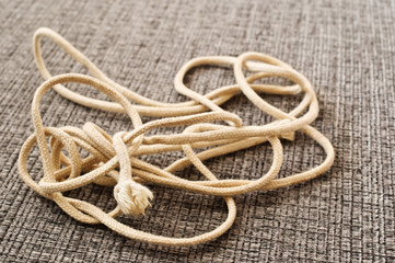 Tangled string on gray fabric.