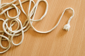 Tangled string on wooden table.