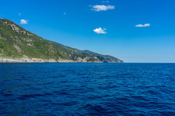 Obraz premium Italy, Cinque Terre, Vernazza, a large body of water with a mountain in the background