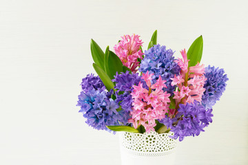 Bouquet of pink hyacinth flowers in vase on white background. Copy space