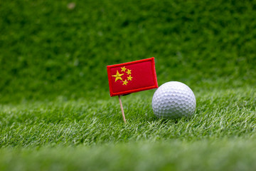 China Flag with golf ball are on green grass