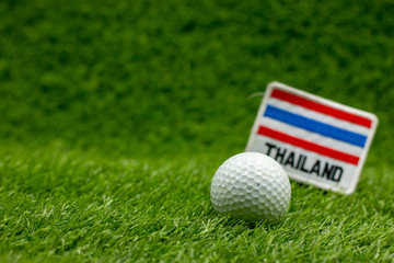 golf ball with Thailand flag are on green grass