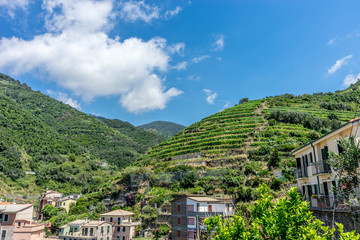 Italy, Cinque Terre, Vernazza, a bus that is parked on the side of a mountain