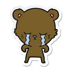 sticker of a crying cartoon bear