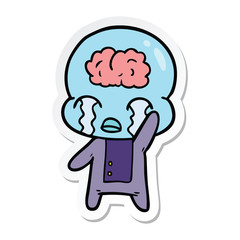 sticker of a cartoon big brain alien crying