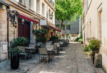 Fototapeta na wymiar Cozy street with tables of restaurant in Rouen, Normandy, France