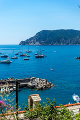 Italy, Cinque Terre, Vernazza, a boat is docked next to a body of water