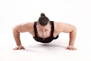 athletic man performs push-up from the floor.isolated on white background