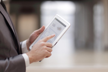 close up.businessman working on a digital tablet with financial