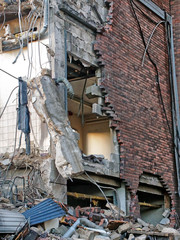 full frame image of a wrecked collapsing building being demolished with smashed brick walls and rubble
