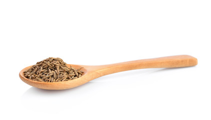 dried cumin seed or caraway in wooden spoon isolated on white background