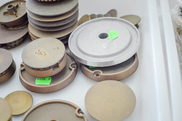 Gas plates spare parts for cooker, product shopping display background. Closeup on golden and gray shiny round shape elements of household appliance.