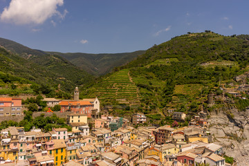 Fototapeta na wymiar Italy, Cinque Terre, Vernazza, Vernazza, HIGH ANGLE VIEW OF TOWNSCAPE AND MOUNTAINS AGAINST SKY
