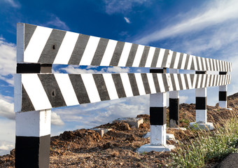 Wood blocks, black and white with sky clouds.