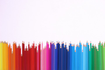 Rainbow Pencils. A row of coloured pencils on a white background