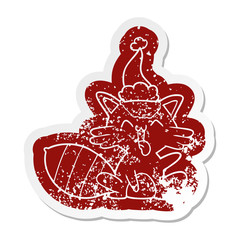 cute cartoon distressed sticker of a raccoon wearing santa hat
