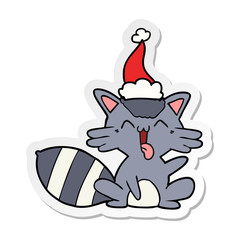 cute sticker cartoon of a raccoon wearing santa hat