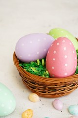 Obraz na płótnie Canvas Multi clored Polka dots Easter eggs in a basket