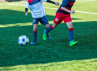 Football training soccer for kids. Boy runs kicks dribbles soccer balls. Young footballers dribble and kick football ball in game. Training, active lifestyle, sport, children activity concept 