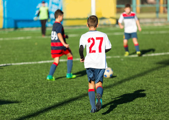 Football training soccer for kids. Boy runs kicks dribbles soccer balls. Young footballers dribble and kick football ball in game. Training, active lifestyle, sport, children activity concept 