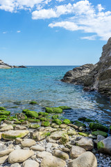 Italy, Cinque Terre, Vernazza, a rocky beach next to a body of water