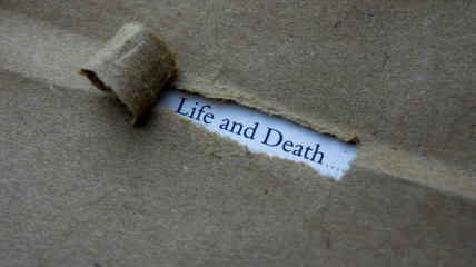 Torn paper with text life and death