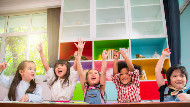 Group Of Multi-ethnic Five Little Kids Children African American, Asian And Caucasian Happiness Together With Friend To Draw Colour Pencil To Full Colour Of Picture In Living Room Or Class Room