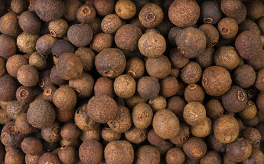 Allspice or Jamaican pepper background. Natural seasoning texture. Natural spices and food ingredients.