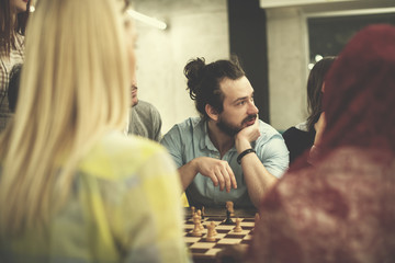 multiethnic group of business people playing chess