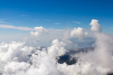Aerial view of clouds formation on sunny day over the mountain