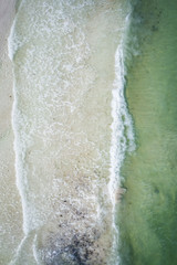 Fototapeta na wymiar Drone waves crashing on beach tropical water birds eye view