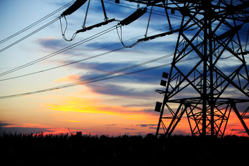 In the evening, the silhouette of high voltage towers