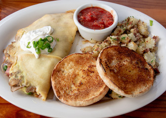 Tortilla breakfast  plate with english muffins, potatoes and sauce