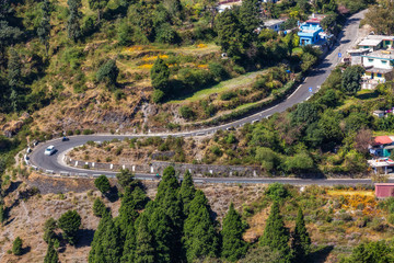 Fototapeta na wymiar Scenic mountain road with cityscape in aerial view from mountain top at Munsiyari Uttarakhand India.