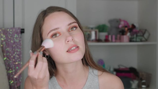 beautiful teenage girl vlogger filming makeup tutorial sharing beauty video enjoying social media influencer recording vlog at home