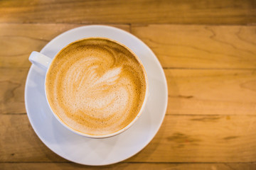 cup of coffee on wooden table