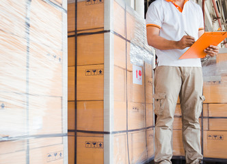 Workers Holding Clipboard Doing Inventory Management in Storage Warehouse. Cargo Supply Chain....