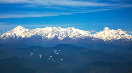 Kumaon Himalayan mountain range with view of flying migratory birds as viewed from Binsar zero point Uttarakhand India.