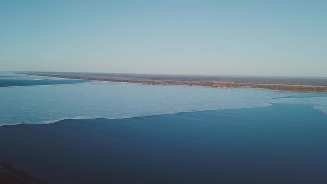 Vyshgorod quay - Kyiv reservoir. Winter aerial shots with deep water color at sunset and beautiful nature