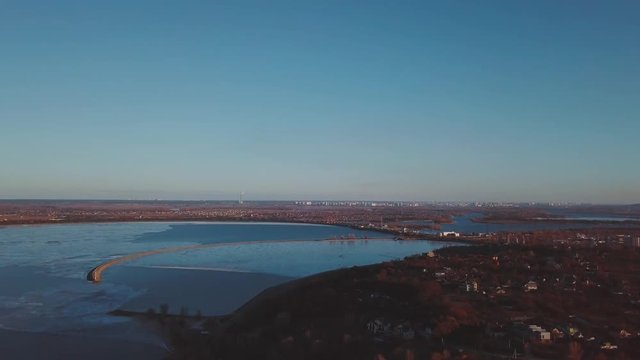 Vyshgorod quay - Kyiv reservoir. Winter aerial shots with deep water color at sunset and beautiful nature