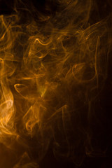 Gold smoke on black background.