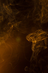 Gold smoke on black background.