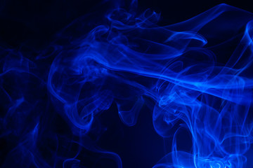 Blue smoke on black background.