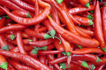 many red hot peppers on the counter on the market