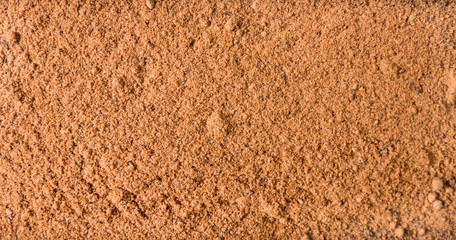 milled or ground nutmeg background. Natural seasoning texture. Natural spices and food ingredients.
