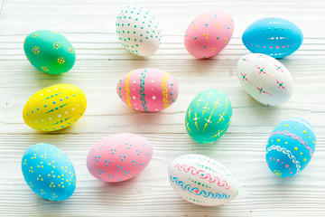 Colorful Easter eggs background on white wooden
